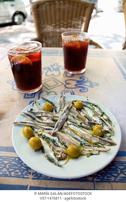 Spanish appetizer: Pickled anchovy fillets and two glasses of sangria in a terrace. Madrid, Spain