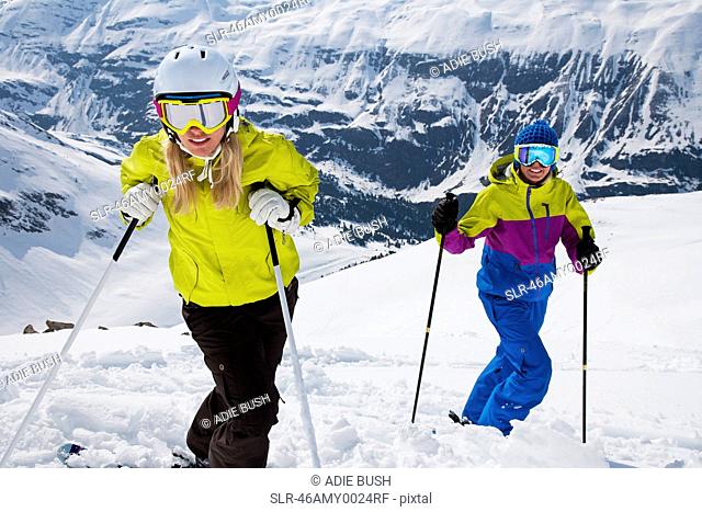 Skiers standing on snowy slope