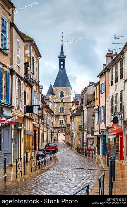 Street with historical clock tower in Avallon, France