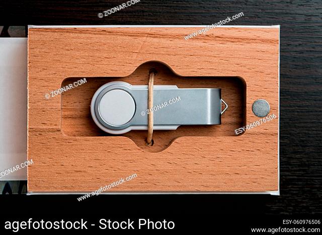 Packaging for USB drives. Box with usb-stick for photographer. Wooden boxes with usb stick on dark wooden background