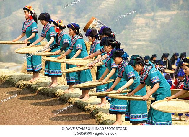 Hani Akha women sifting rice at a festival in Yuanyang China