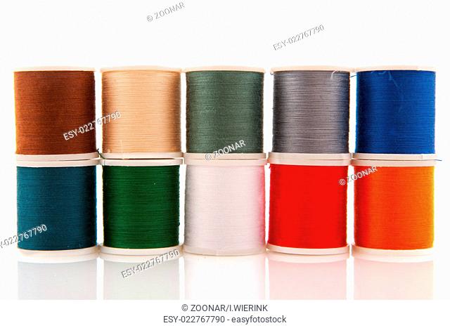 Colorful sewing threads on white spools