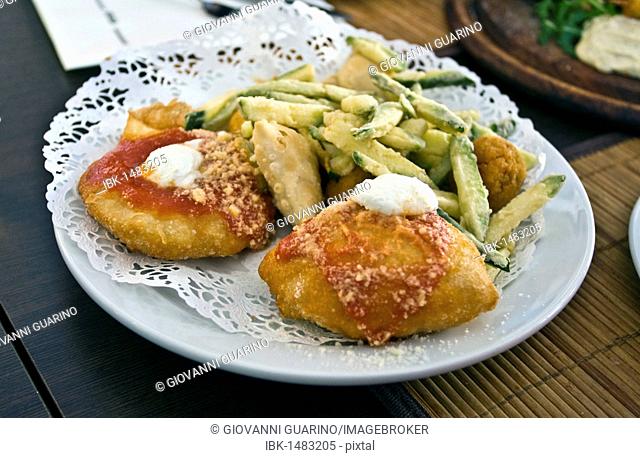 Mix of fried appetizers with Montanara pizza and fried zucchini, Italian fries