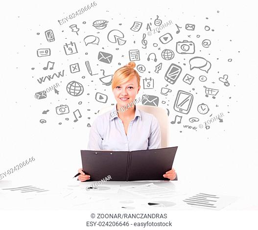 Young businesswoman with all kind of hand-drawn media icons in background