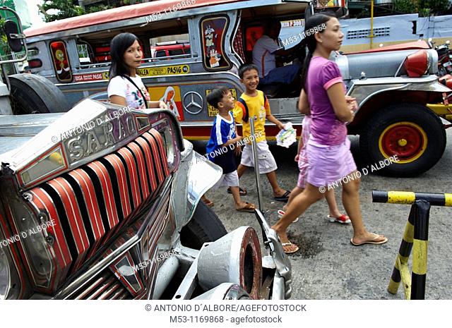 Filipino people walk trough jeepneys, the most popular transportation vehichle in the philippines  Mandaluyong City  Metro Manila  Philippines