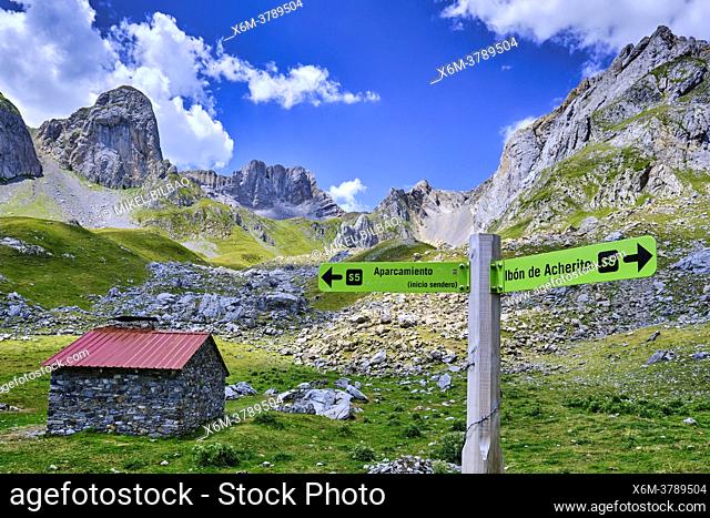 Mountains landscape and a cabin and signs in Ibon de Acherito route. Valles Occidentales Natural Park. Hecho valley. Pyrenees mountain Range, Huesca, Aragon