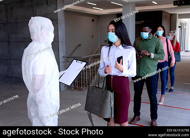 Group of people wearing face masks standing in queue