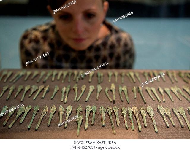 A museum employee looks bronze arrowheads in the exhibition 'Treasures of Vietnamese Archaeology' at the LWL Museum of Archaeology in Herne,  Germany
