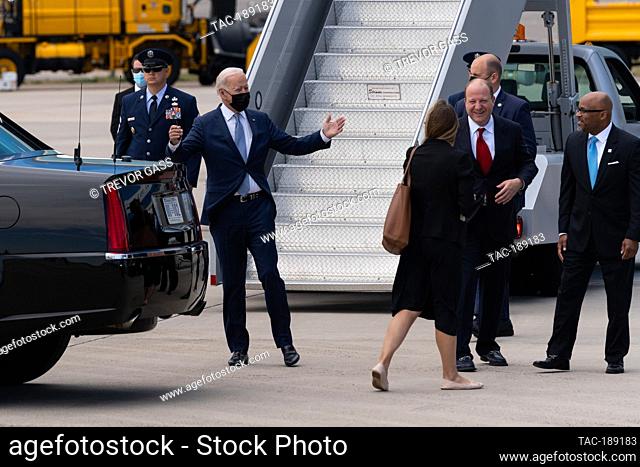President Joe Biden bids farewell to Colorado Governor Jared Polis and Denver Mayor Michael B. Hancock at Denver International Airport in Denver, Colorado