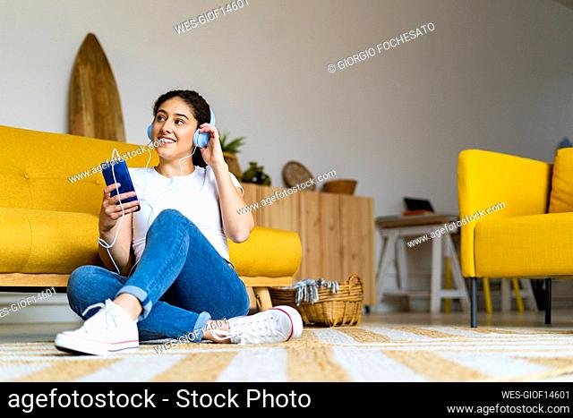 Woman listening music sitting at home