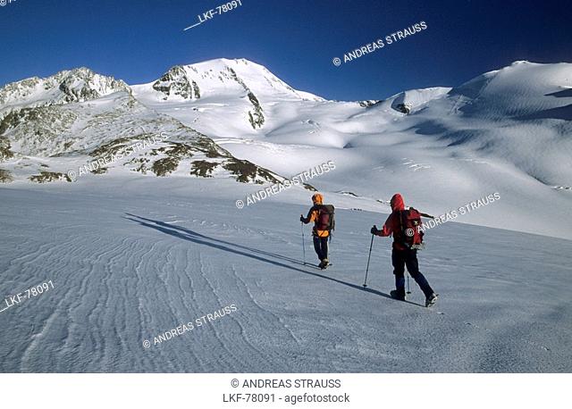 two mountaineerers on their way to glacier Hintereisferner beneath Weisskugel, oetztal range, Tyrol, Austria