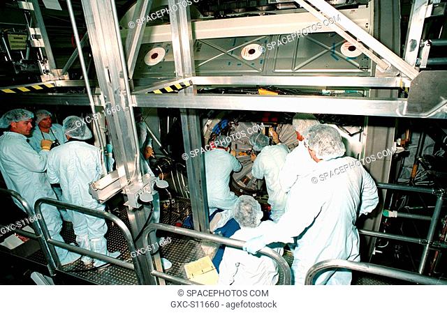 09/21/1998 --- Workers in the Space Station Processing Facility close the access hatch to the Unity connecting module, part of the International Space Station