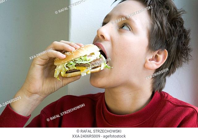 boy eating hamburger