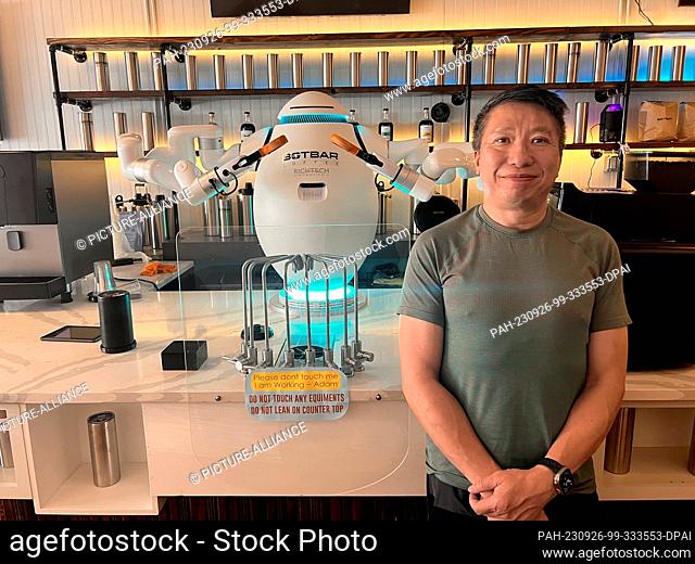 PRODUCTION - 18 August 2023, USA, New York: Sunny Lam, founder of the Botbar Cafe in Brooklyn's Greenpoint neighborhood, stands next to barista Adam and is the...