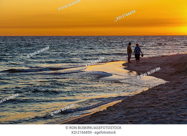 Couple on the beach during sunset at Gulf Shores, Alabama