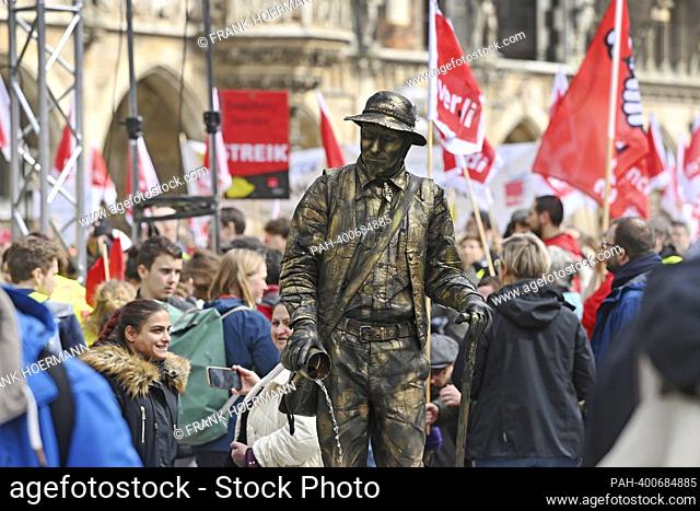 Theme image major strike day at Marienplatz in Munich on March 21, 2023. A street performer inwithten the strikers. Daycare centers, clinics