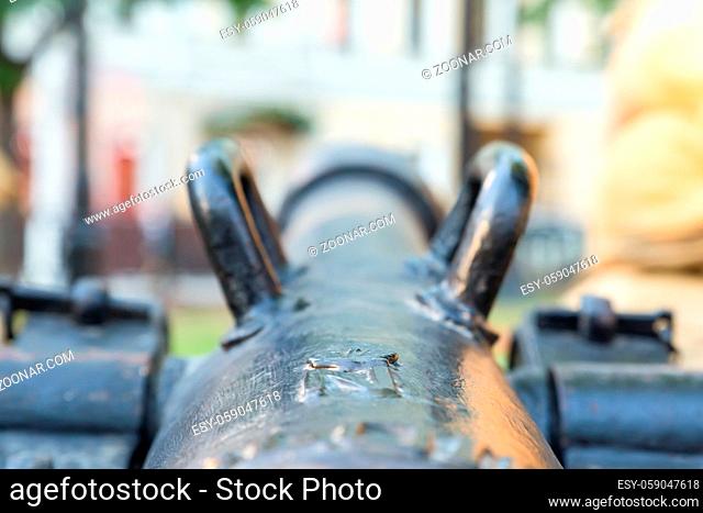 large cannon, view along the long trunk of the black foreshortening on carrying handles