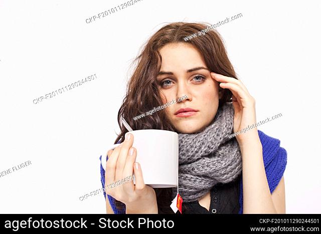 A beautiful young woman, lady, girl, cold, runny nose, headache, cup of tea, scarf  (CTK Photo/Rene Fluger) MODEL RELEASED, MR