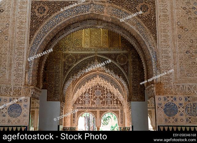 Granada, Spain - 5 February, 2021: view of detailed and ornate Moorish and Arabic decoration in the arched windows of the Nazaries Palace