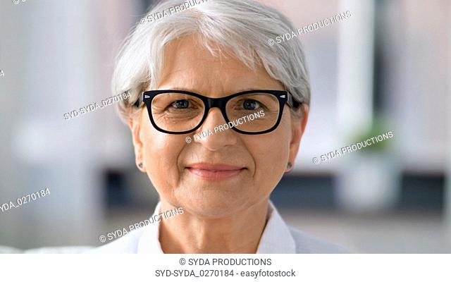 portrait of happy senior woman in glasses