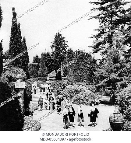 Some tourists walking in the Palazzo Borromeo Italianate gardens in Isola Bella. Stresa, 1960s