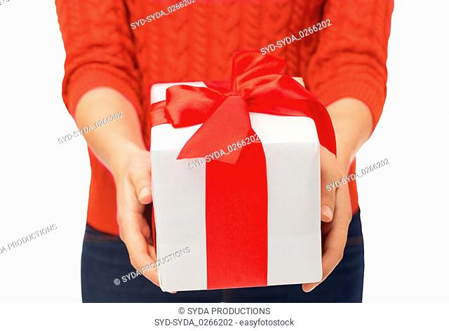 close up of woman in red sweater holding gift box