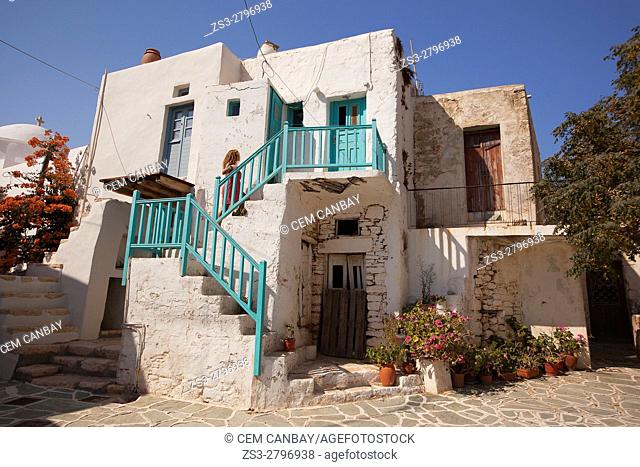 Woman at the stairs of a traditional Cyclades houses in the old town Kastro, Chora, Folegandros, Cyclades Islands, Greek Islands, Greece, Europe