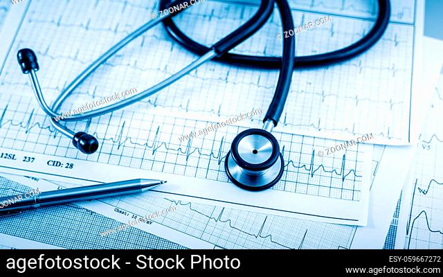 Stethoscope on cardiogram concept for heart care on the desk
