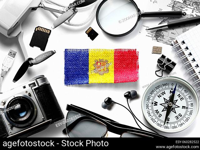 Flag of Andorra and travel accessories on a white background. The view from the top