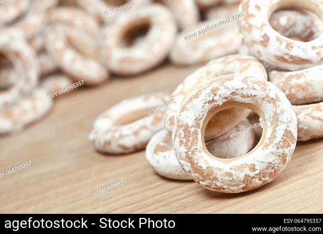 Still life of donut glaze on a wooden surface. Glazed bagels are a small bunch on a wooden table. Flour sweets to the Tea Party