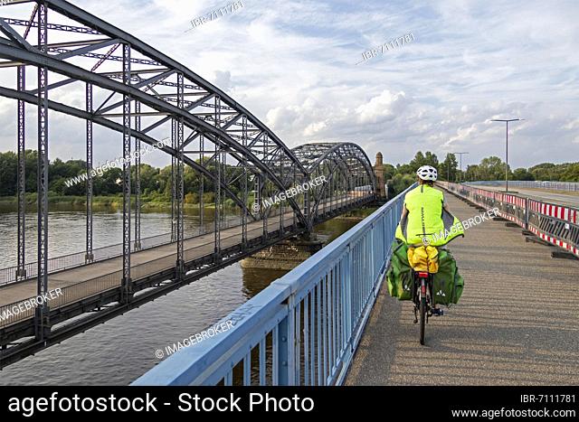 Woman riding her bicycle over bridge next to the Alte Harbrücker Elbbrücke, Brücke des 17. Juni, Harburg, Hamburg, Germany, Europe