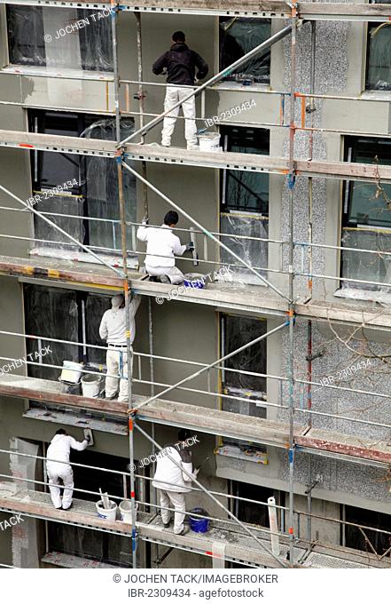 Construction site of a multi-storey residential building, exterior facade is rendered after the installation of thermal insulation, Essen, Ruhr Area