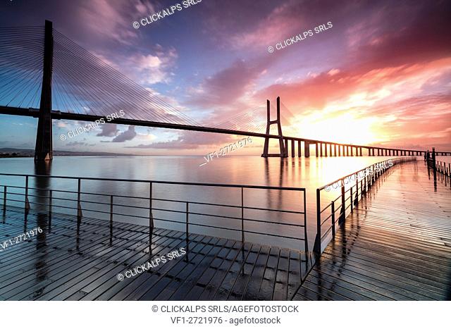 Perspective and architecture of Vasco Da Gama bridge enhanced by the colors of dawn Lisbon Portugal Europe