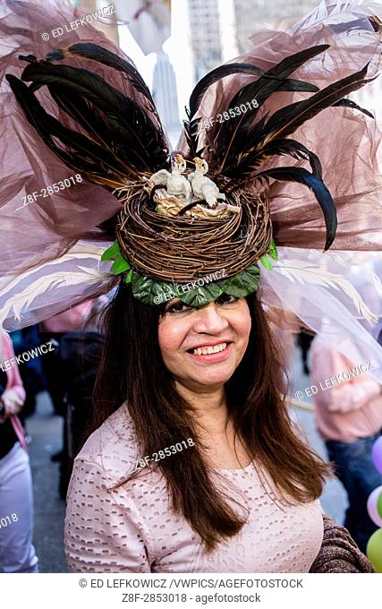 New York, NY - April 16, 2017. A woman wih a hat topped by a bird's nest with chicks, and with a huge spray of feathers and gauze