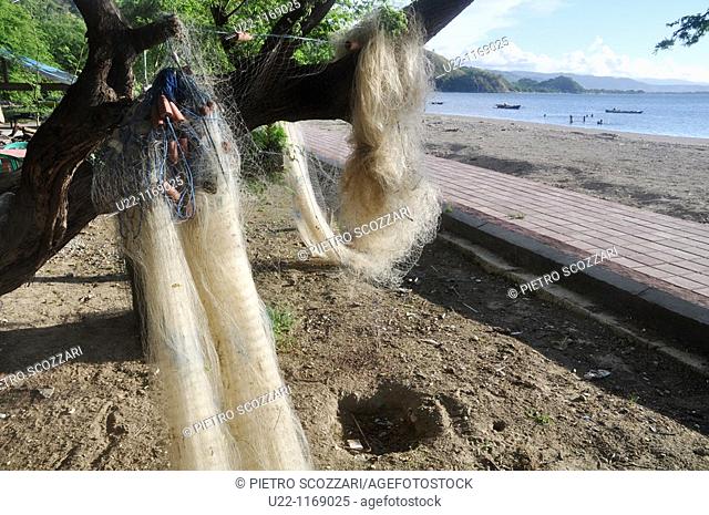 Dili (East Timor): fishing nets on a tree at a beach near Areia Branca