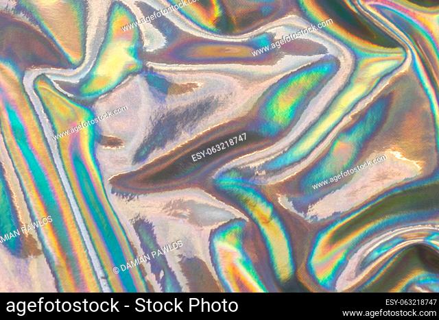 Metallic texture with a wrinkled colorful surface. Abstract neon background texture