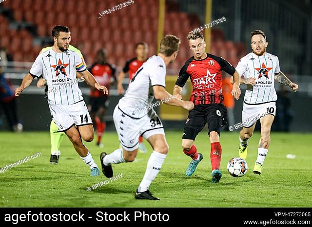 Cercle's Charles Vanhoutte, Cercle's Thibo Somers, Seraing's Mathieu Cachbach and Cercle's Dino Hotic fight for the ball during a soccer match between RFC...