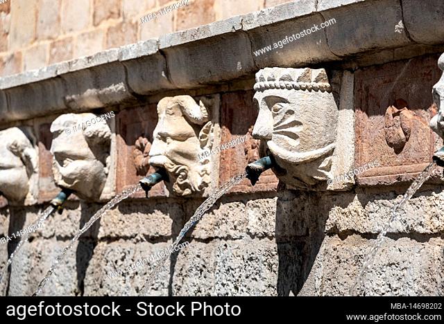 Famous mediaeval Fountain of 99 Spouts in ithe old town of L'Aquila, Abruzzi in Italy