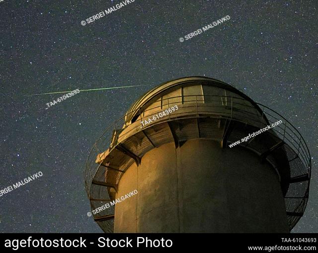 RUSSIA, REPUBLIC OF CRIMEA - AUGUST 13, 2023: A view of a falling star of the Perseid meteor shower in the sky over the Crimean Astrophysical Observatory in the...