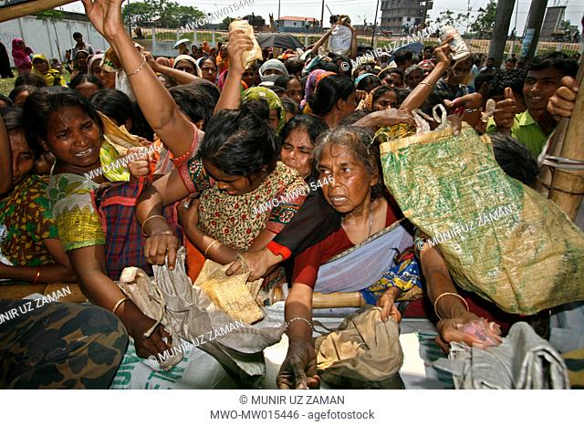 People from low income group crowd at a fair price shop, run by Bangladesh Rifles or BDR, to collect rice Global rice stock has reached the lowest in the last...