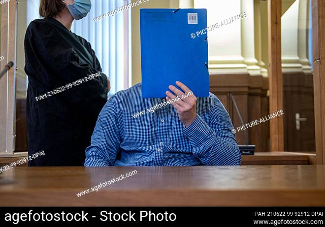 22 June 2021, Saxony, Leipzig: An accused man sits in the courtroom of the regional court. The prosecution accuses defendants of having rammed a knife into the...