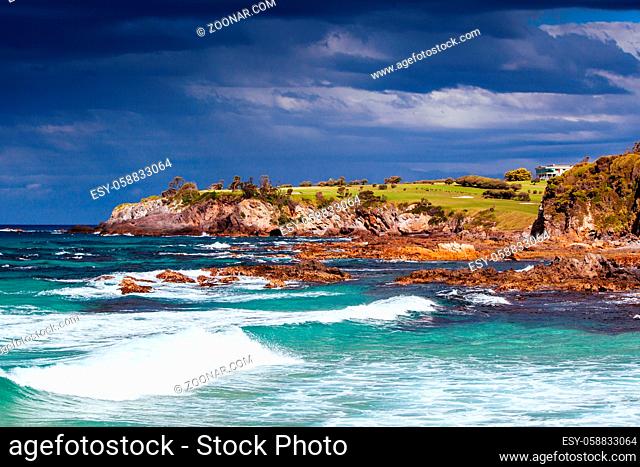 View towards Narooma Golf Course and Glasshouse Rocks Beach on a stormy day in New South Wales, Australia