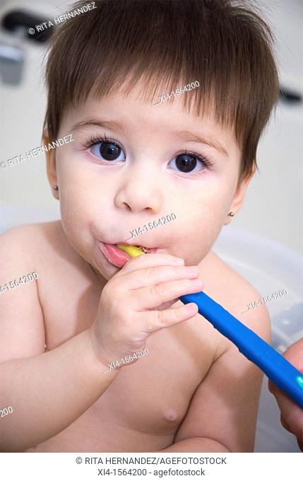 Baby brushing teeth  Looking at the camera