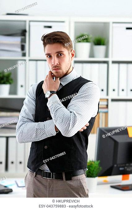 Handsome man in suit and tie stand in office looking in camera hands crossed on chest. White collar dress code modern office lifestyle graduate college study...