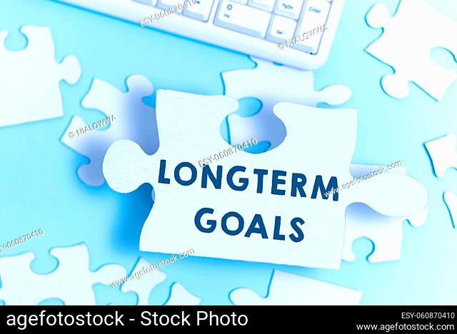 Hand writing sign Longterm Goals, Internet Concept Strategic target that is required more time for completion Building An Unfinished White Jigsaw Pattern Puzzle...