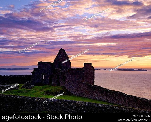 europe, northern ireland, county antrim, causeway coast, evening sky over dunluce castle