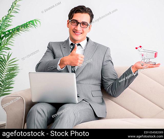 The businessman with laptop and shopping cart