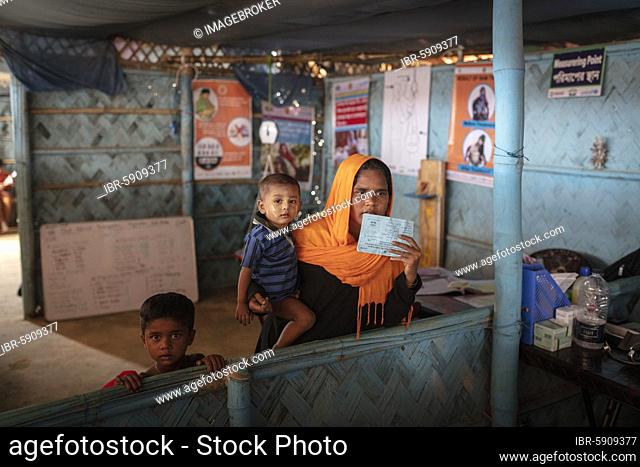 A mother with her children in a medical station in the camp for Rohingya refugees from Myanmar, Kutupalong, Cox Bazar, Bangladesh, Asia
