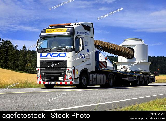 Exceptional load of industrial equipment by white Volvo FH semi trailer of Portuguese LASO Transportes SA, highway 52, Salo, Finland. July 22, 2021