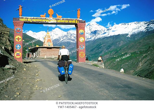 Cyclist entering welcome gate in India